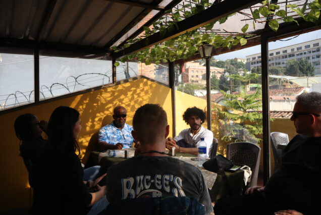 Tour guide sharing cultural stories during a food stop in La Candelaria