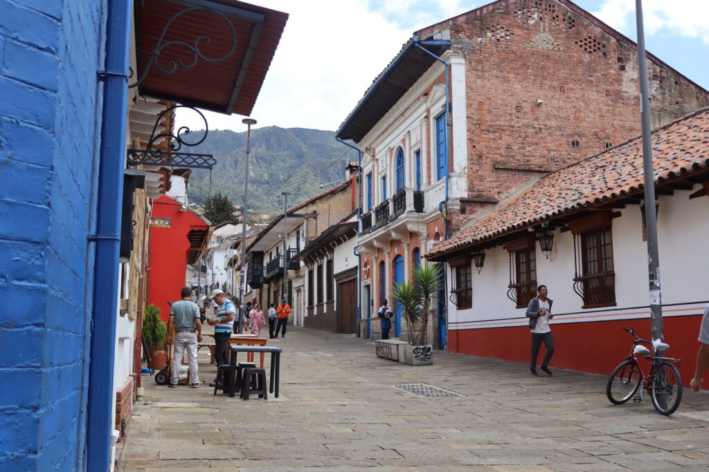 View of Bogotá street leading toward the mountains, blending urban life with the Andean horizon View of Bogotá street leading toward the mountains, blending urban life with the Andean horizon